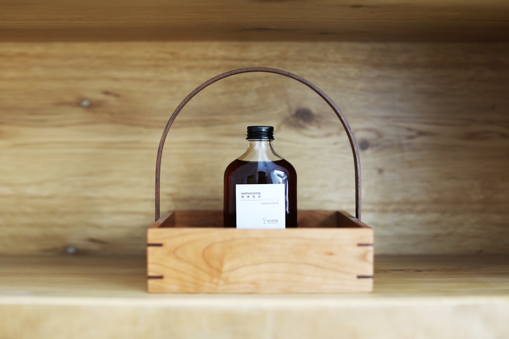 a bottle of maple syrup in a wooden crate