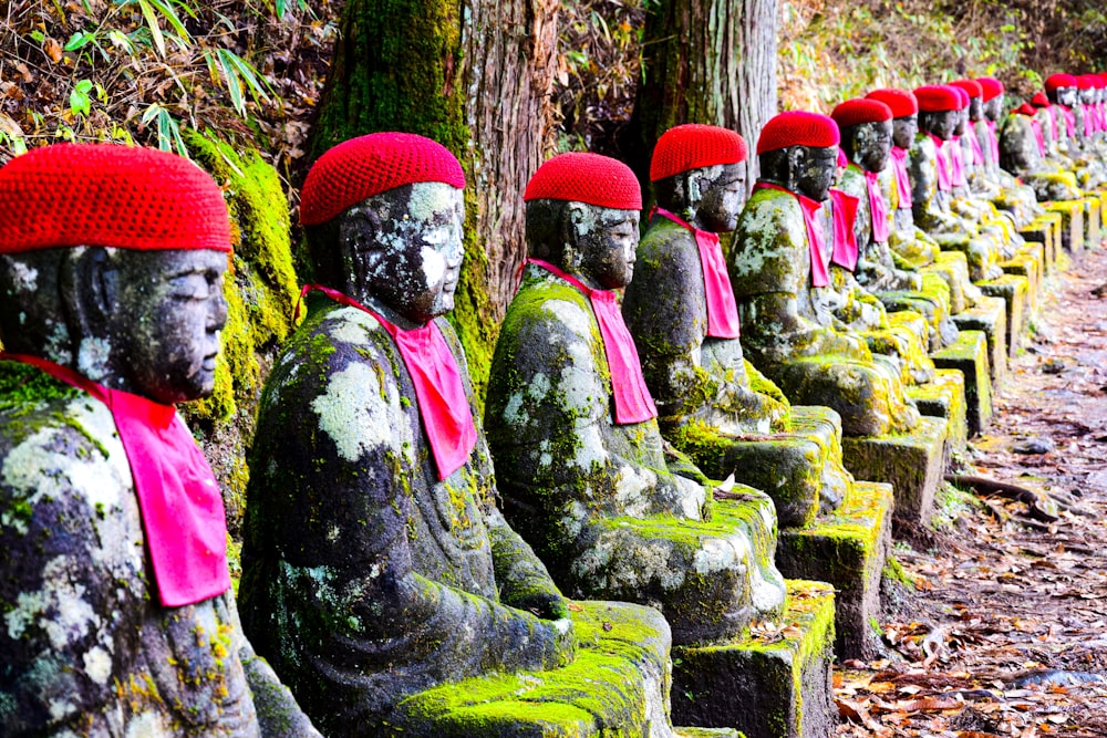 a row of buddha statues sitting next to each other