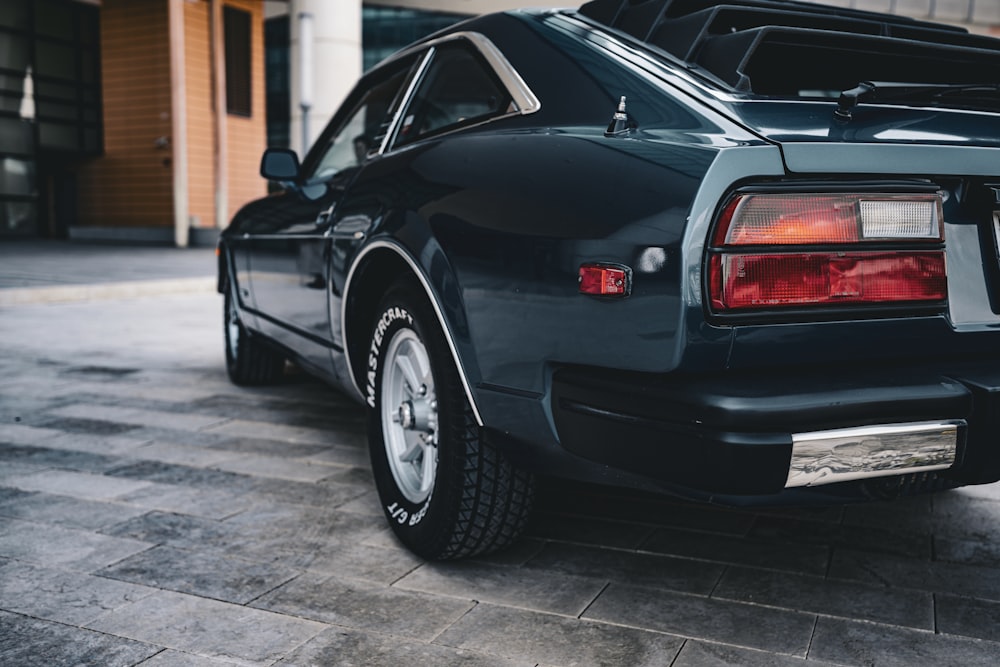 a black car parked in front of a building