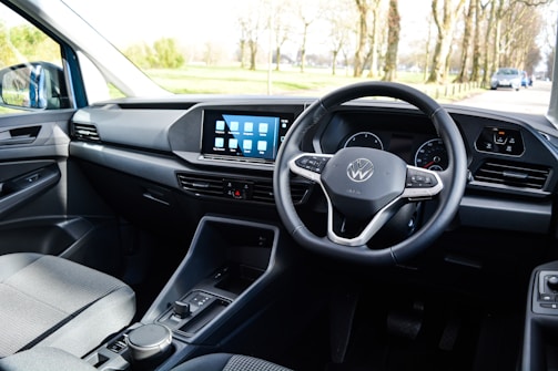 Close-up of the dashboard of a cityfahrschule breuer training car showing clear, minimalistic controls.