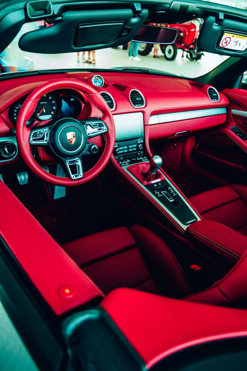 the interior of a sports car with red leather