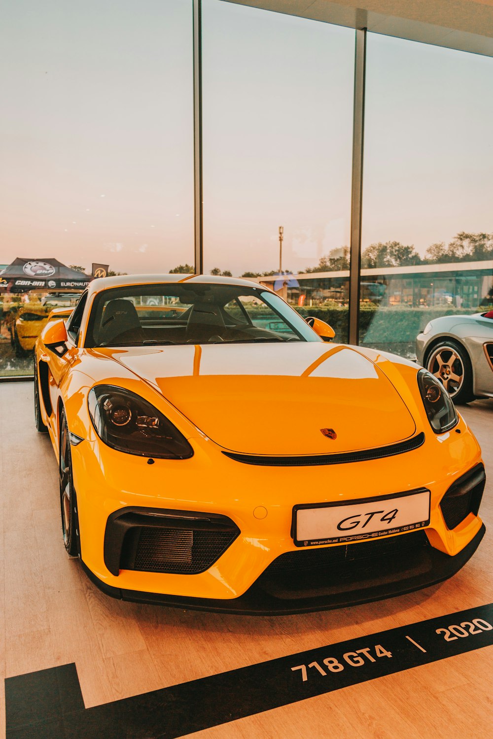 a yellow sports car parked in a showroom