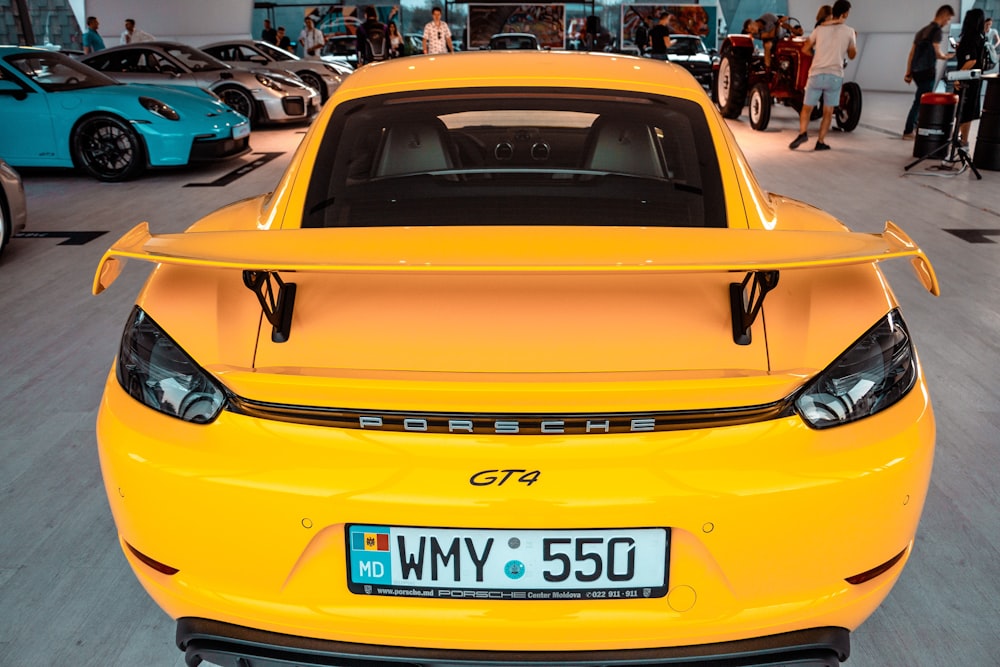 a yellow sports car parked in a showroom