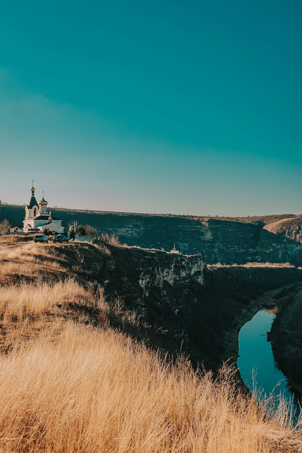 a church on a hill overlooking a body of water