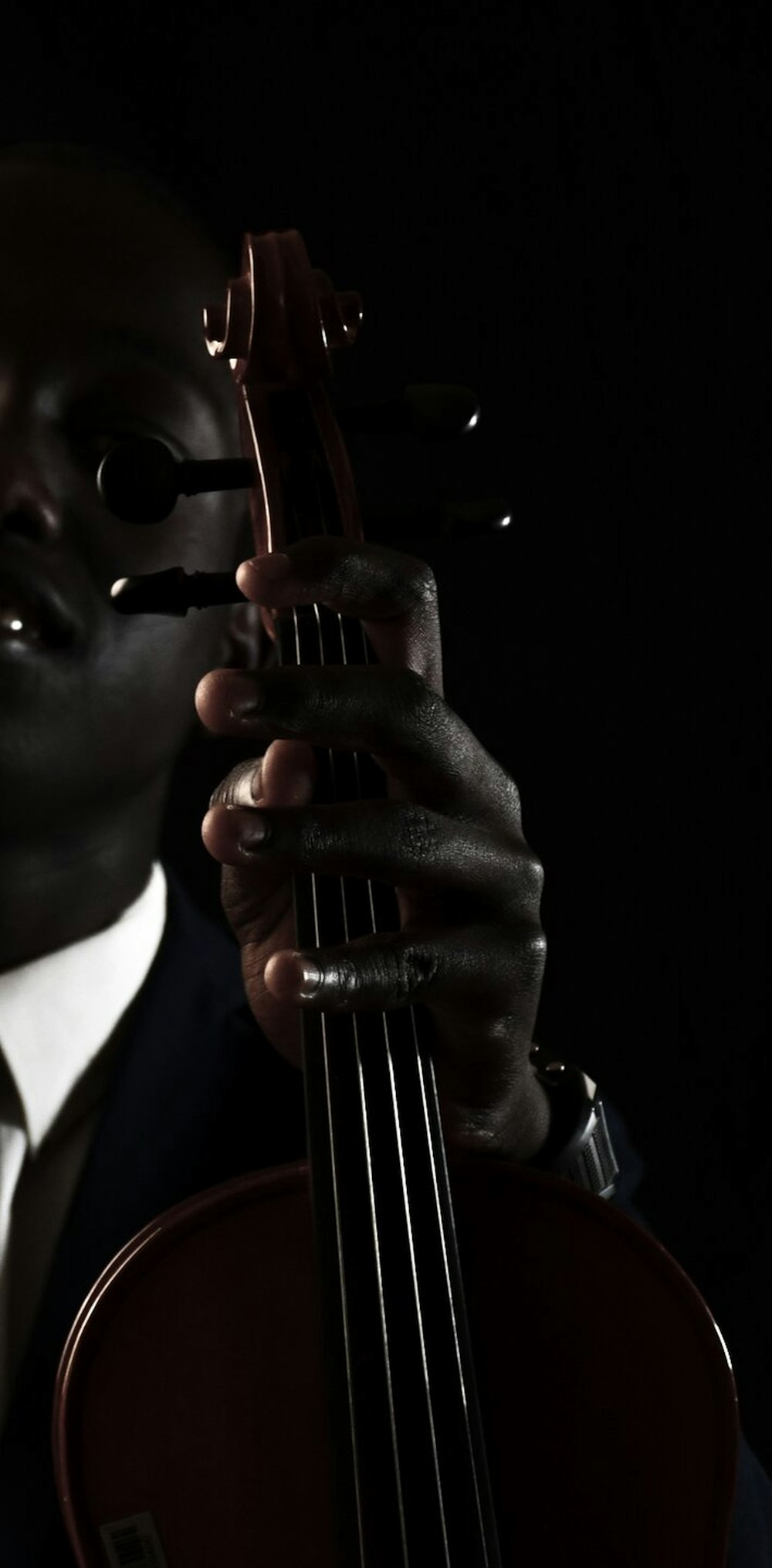 a man in a suit holding a violin