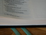 Close-up of an old football rule book open on a wooden table.