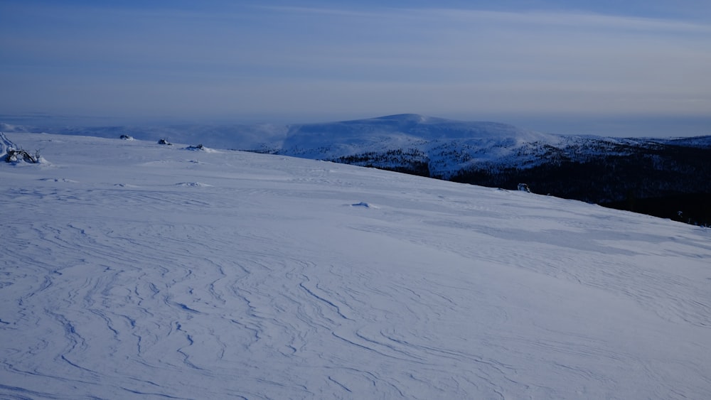 a person riding skis on top of a snow covered slope