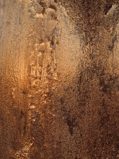 a close up of a wall with a brown substance on it