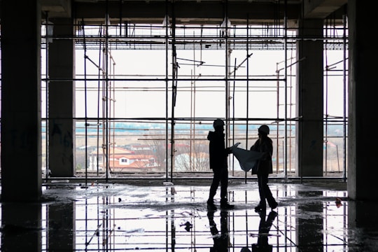 A close-up of construction workers collaborating on a building plan.