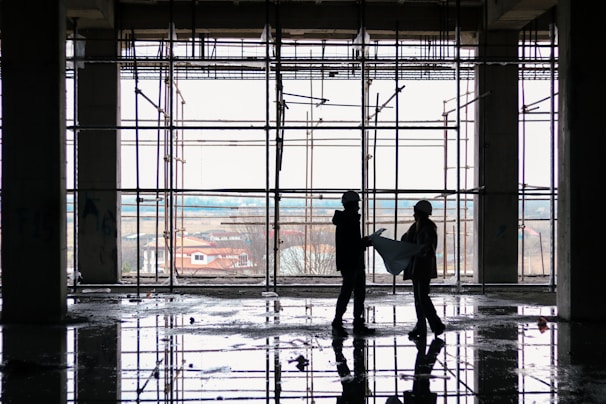 Engineers reviewing blueprints at a construction site office.