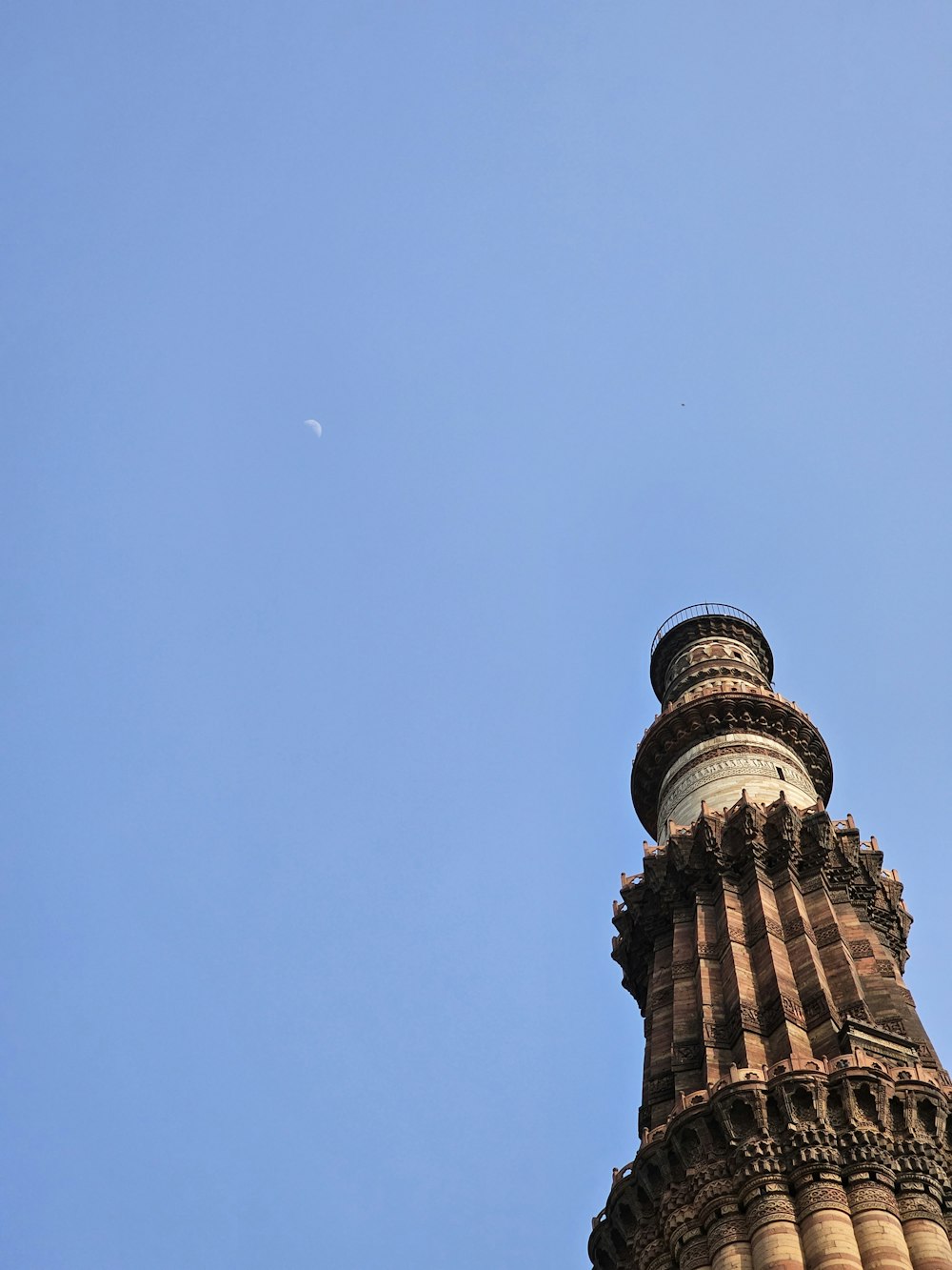 a tall tower with a clock on the top of it