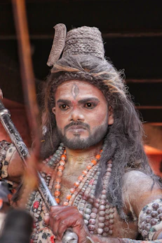 a man dressed in a costume holding a sword