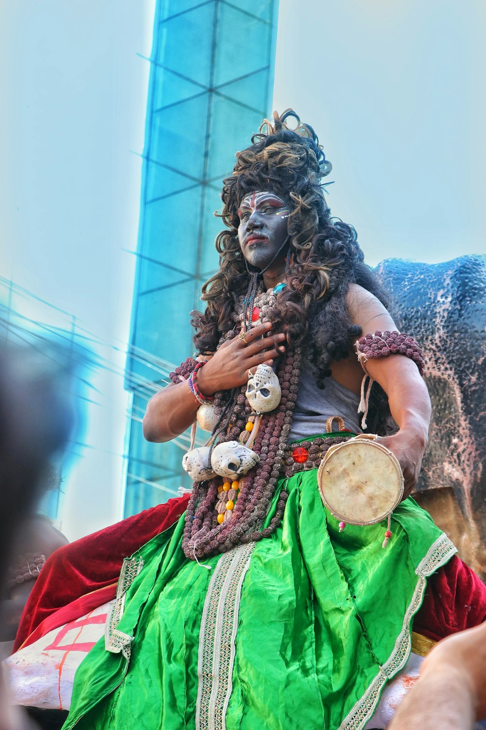 a man dressed in costume sitting on top of a horse