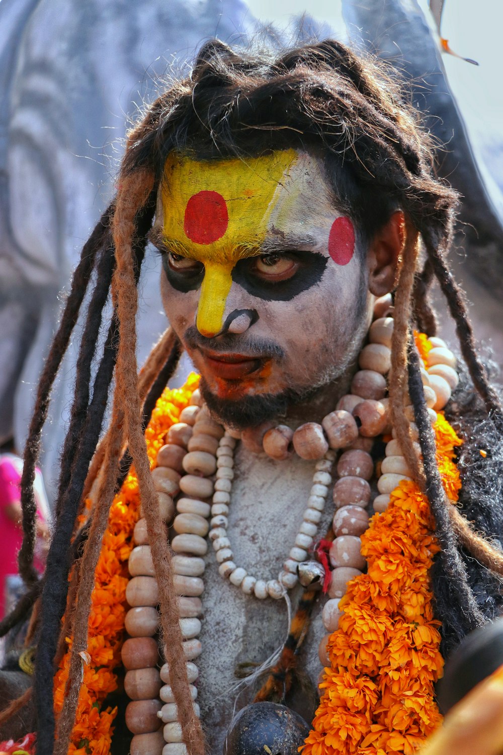 a man with dreadlocks and a painted face