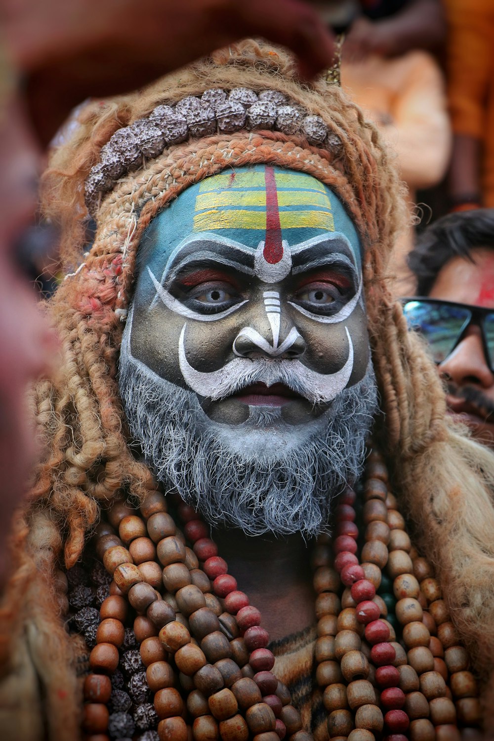 a man with a painted face and a beard