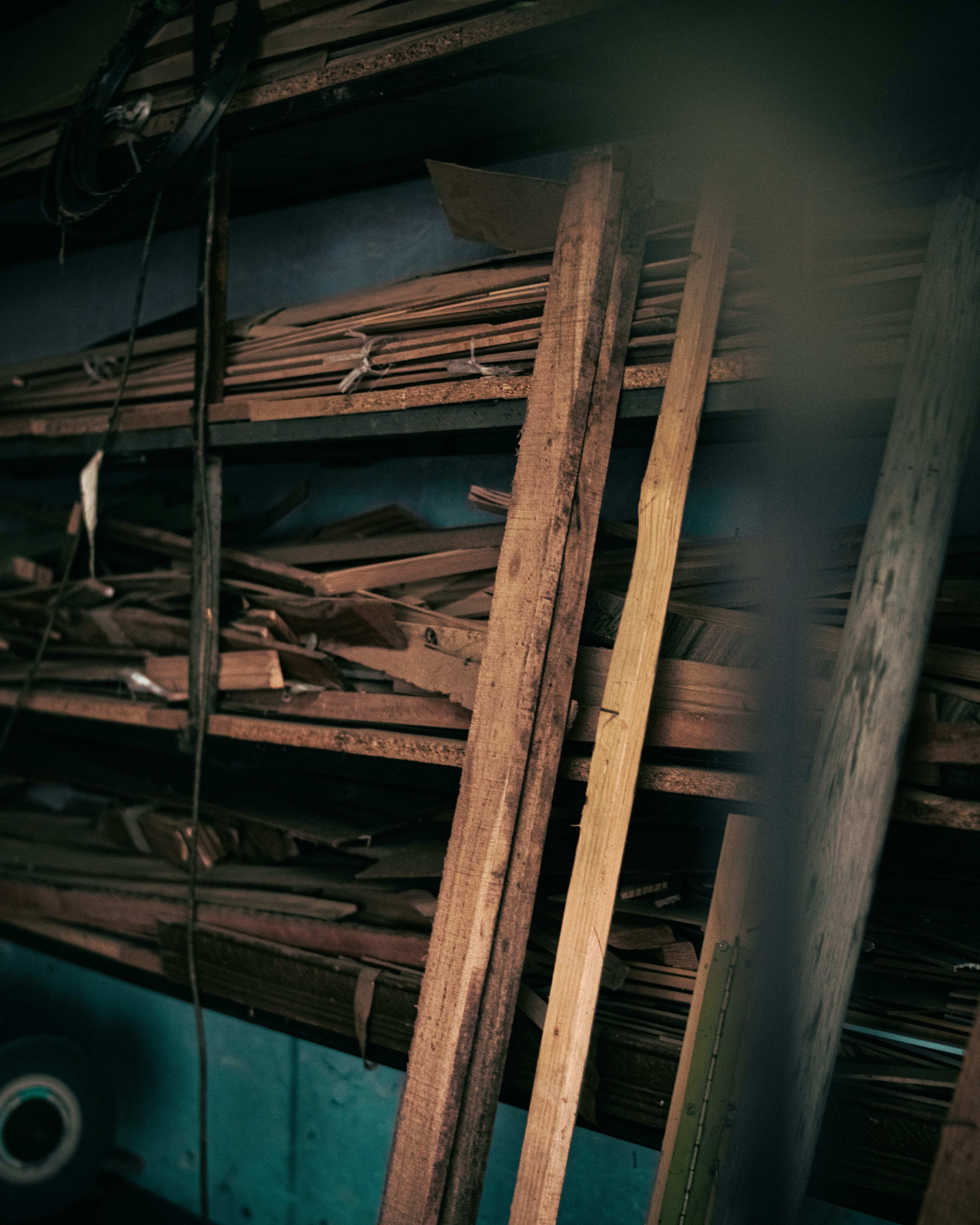 A craftsman working on a piece of wood in a well-lit workshop.