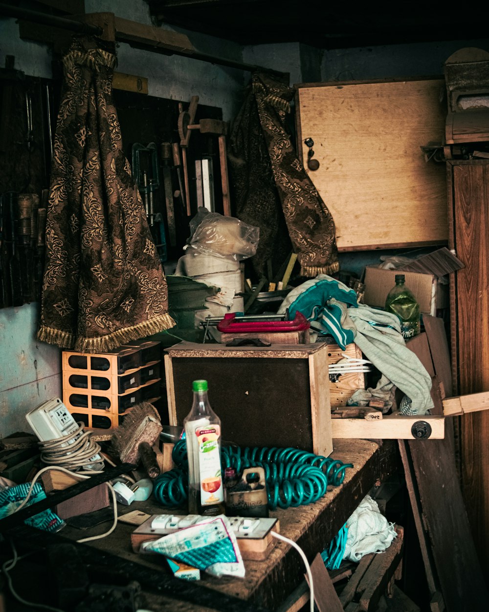a cluttered room with clothes and other items