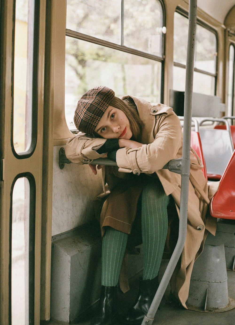 a woman sitting on a bus with her legs crossed