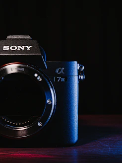 a sony camera sitting on top of a wooden table