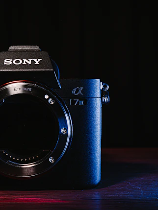 a sony camera sitting on top of a wooden table