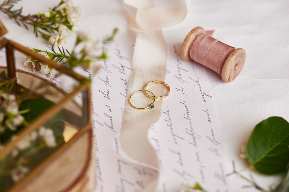 a couple of wedding rings sitting on top of a piece of paper