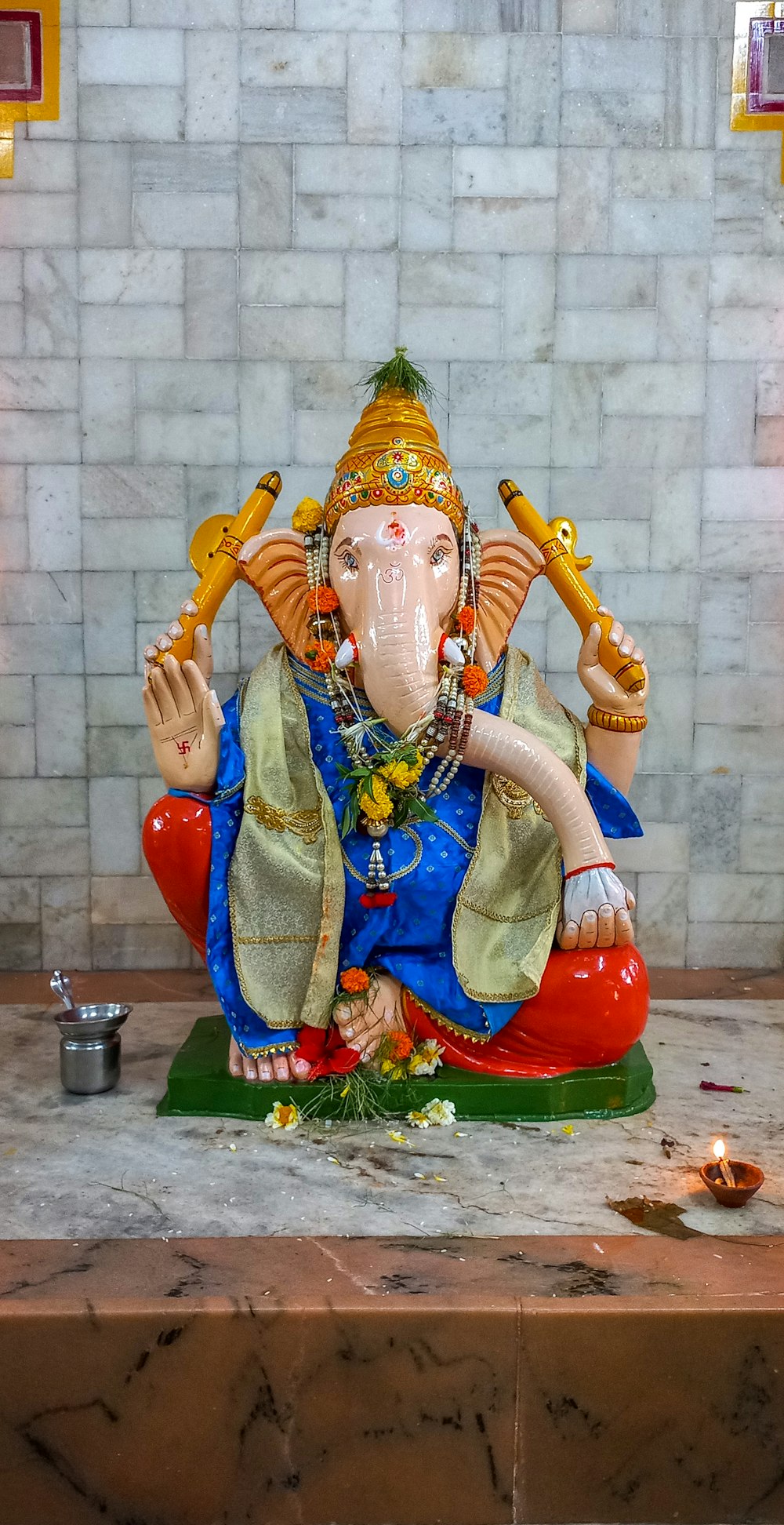 a statue of an elephant sitting on top of a table