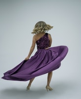 A woman twirling in a chic cocktail dress, showcasing movement.