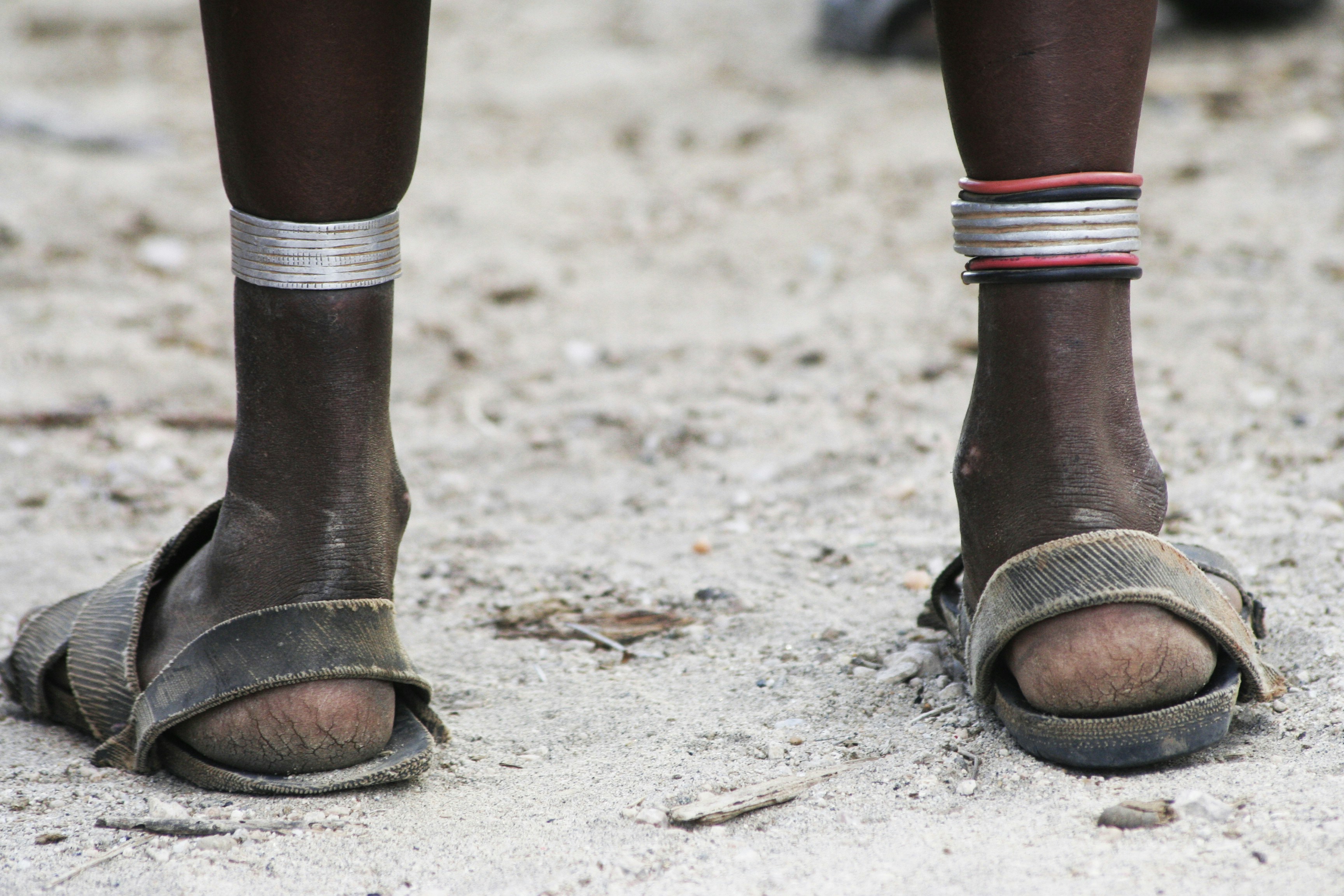 a close up of a person's feet wearing sandals