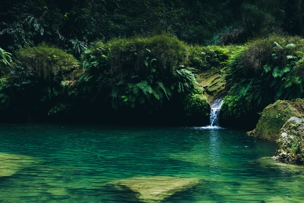 a body of water with a waterfall in the middle of it