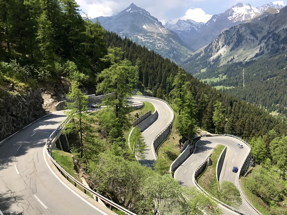 a curved road in the middle of a mountain range