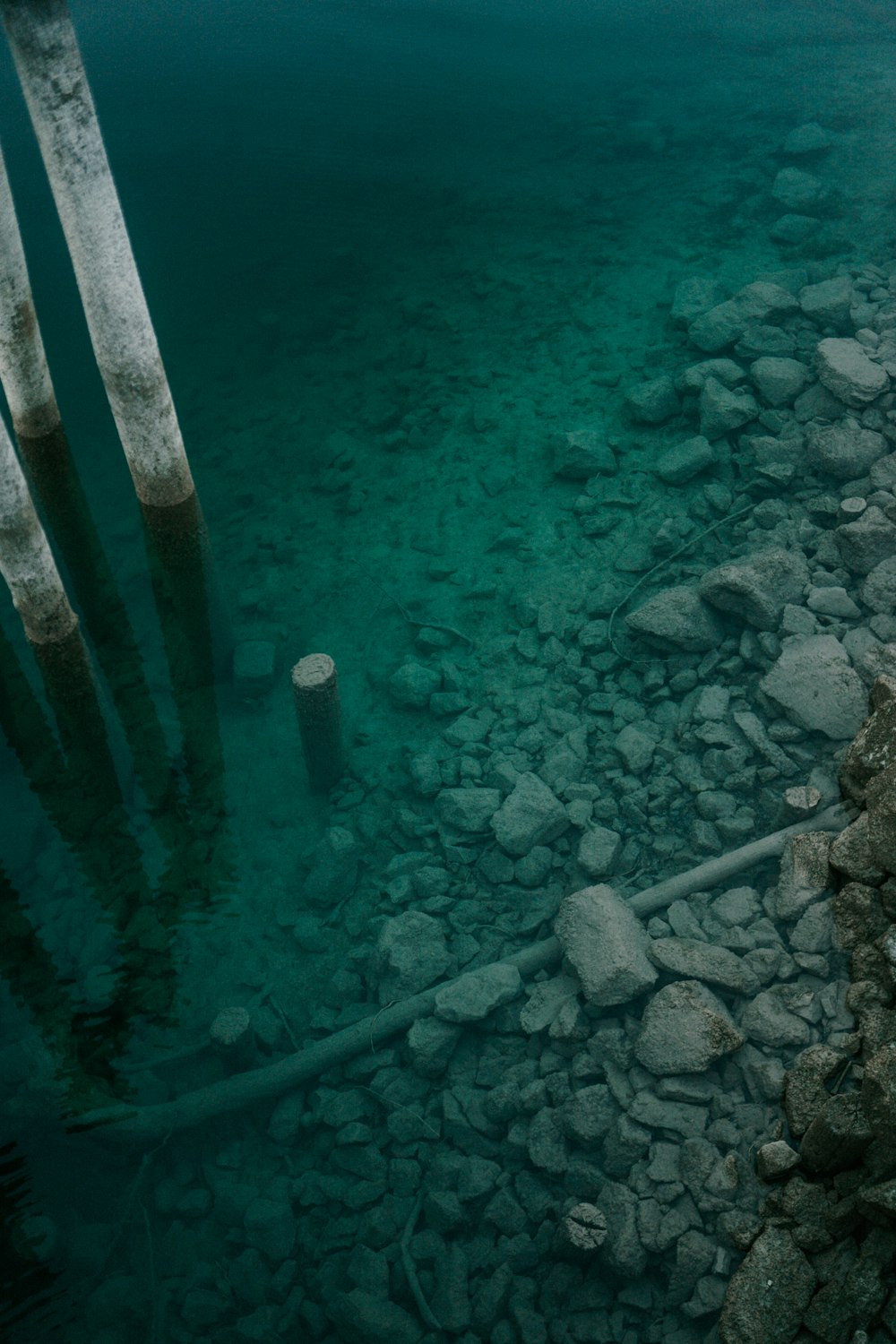 a body of water surrounded by rocks and a dock