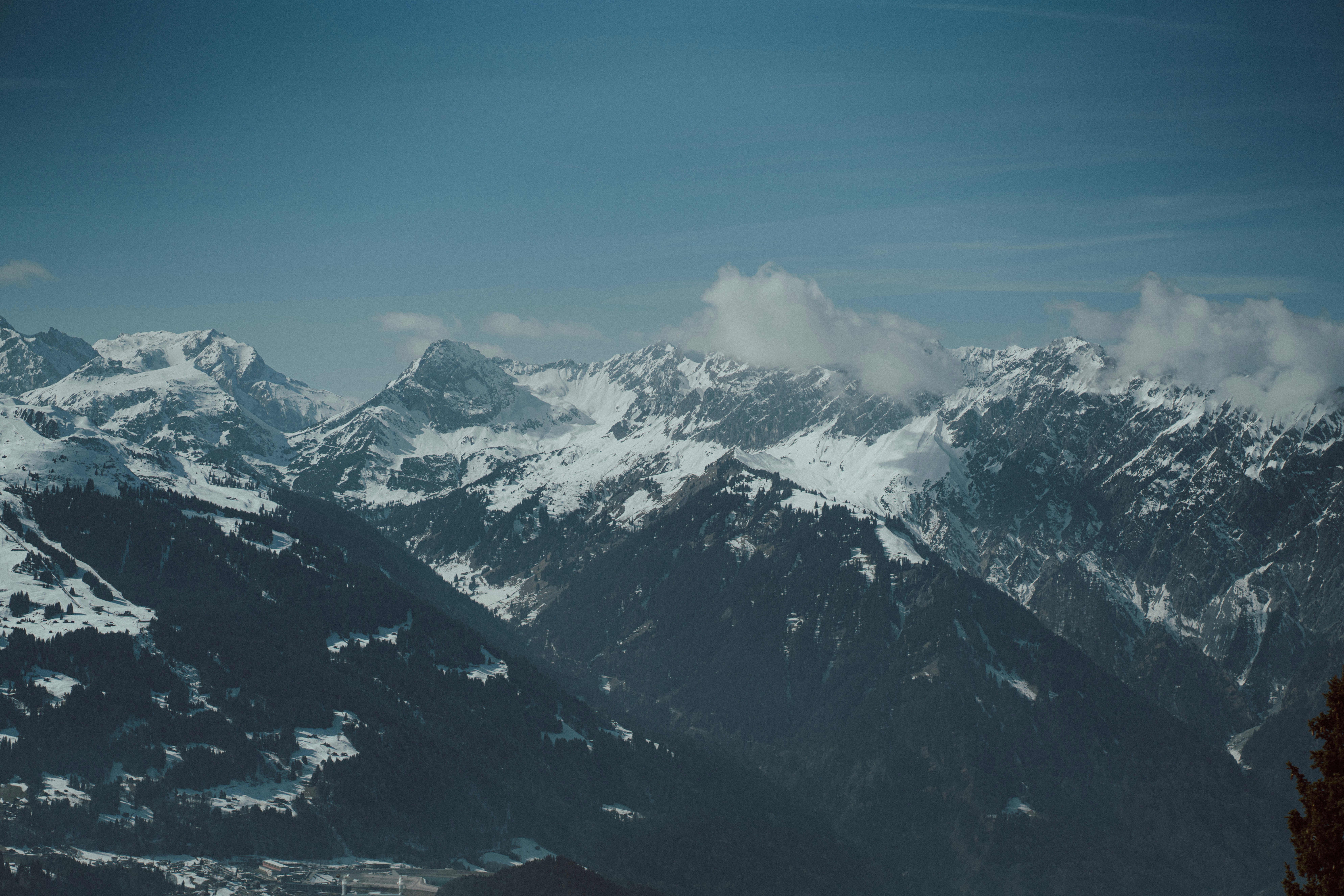 a mountain range with snow covered mountains in the background