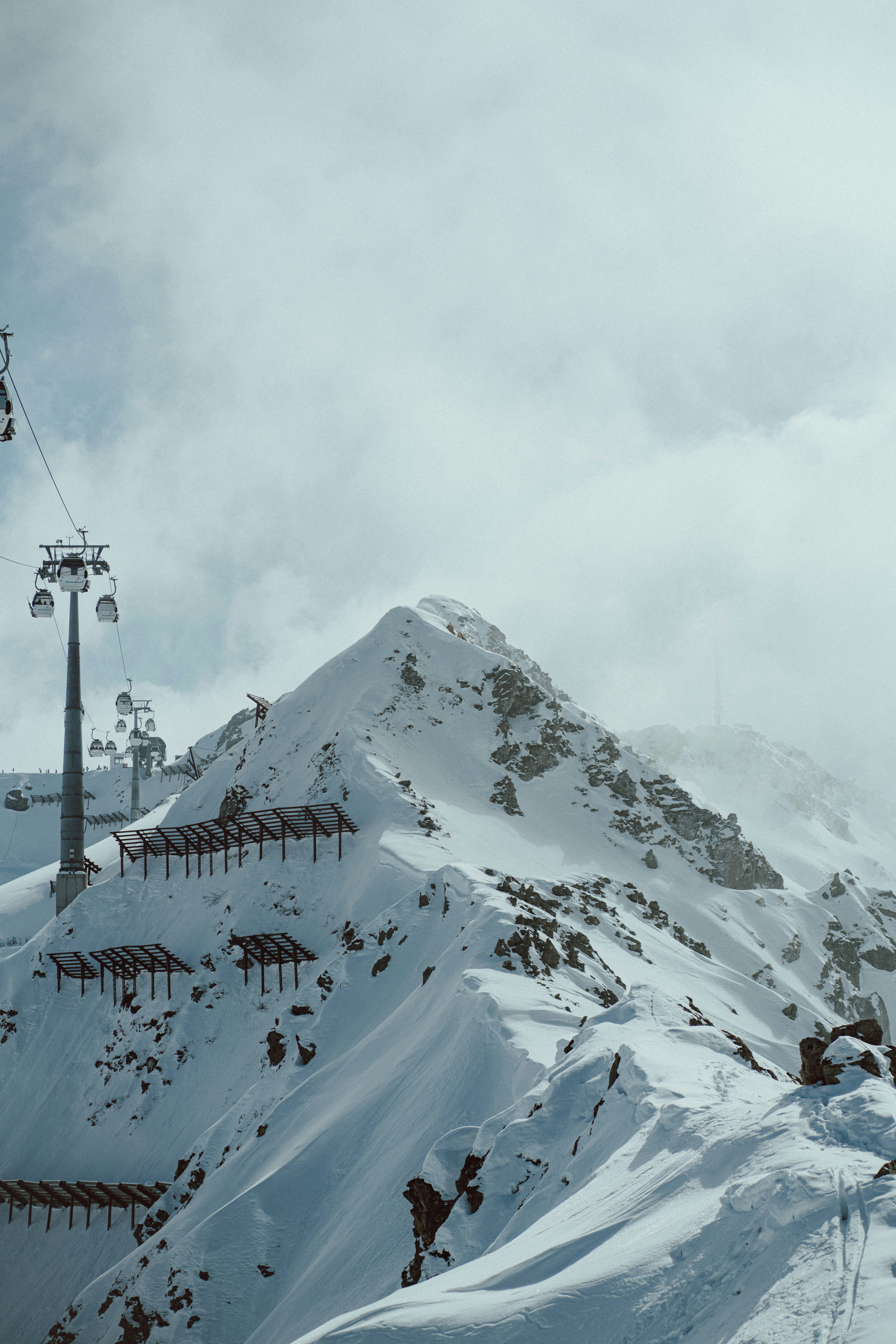 a ski lift going up a snowy mountain