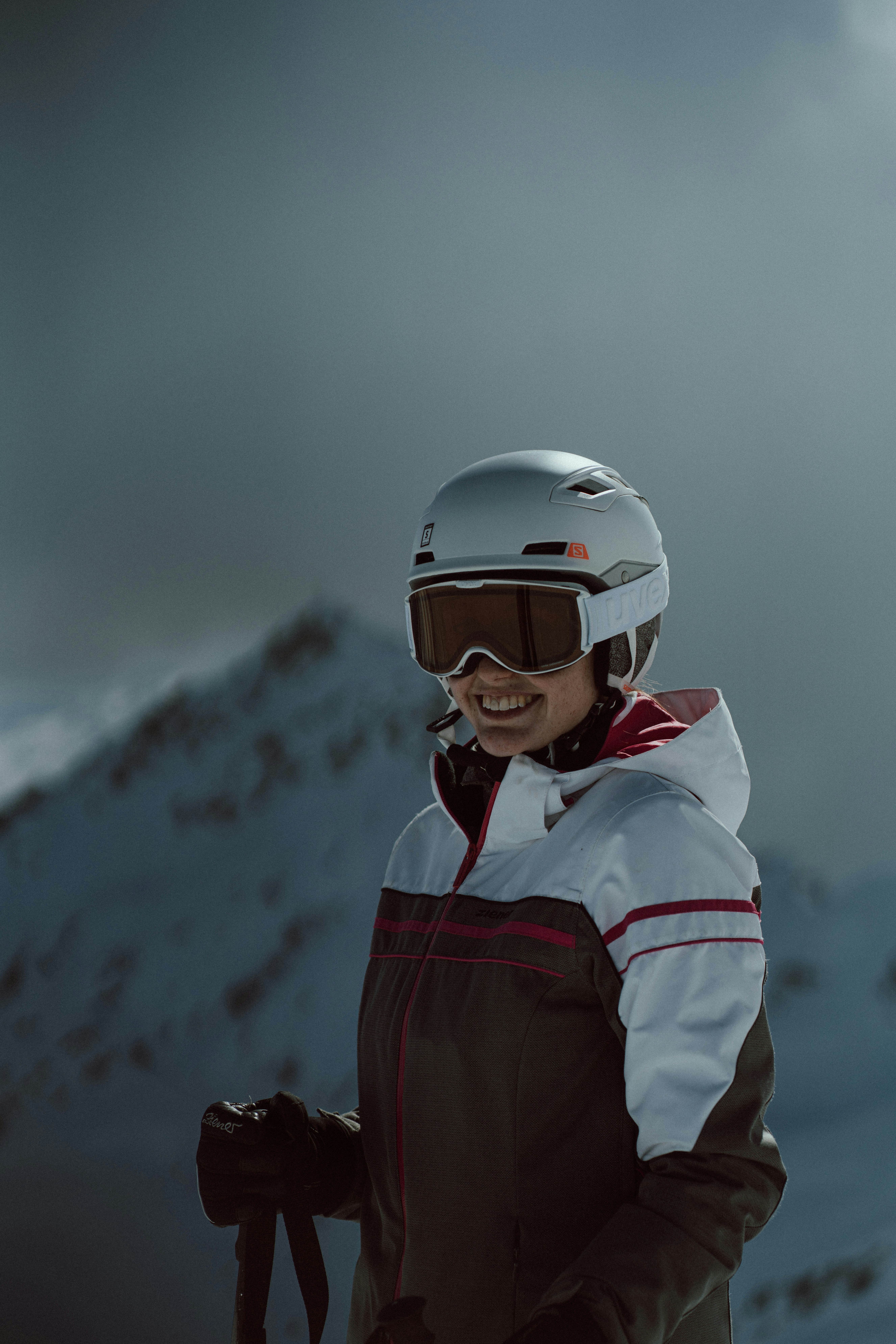 a woman standing on top of a snow covered slope