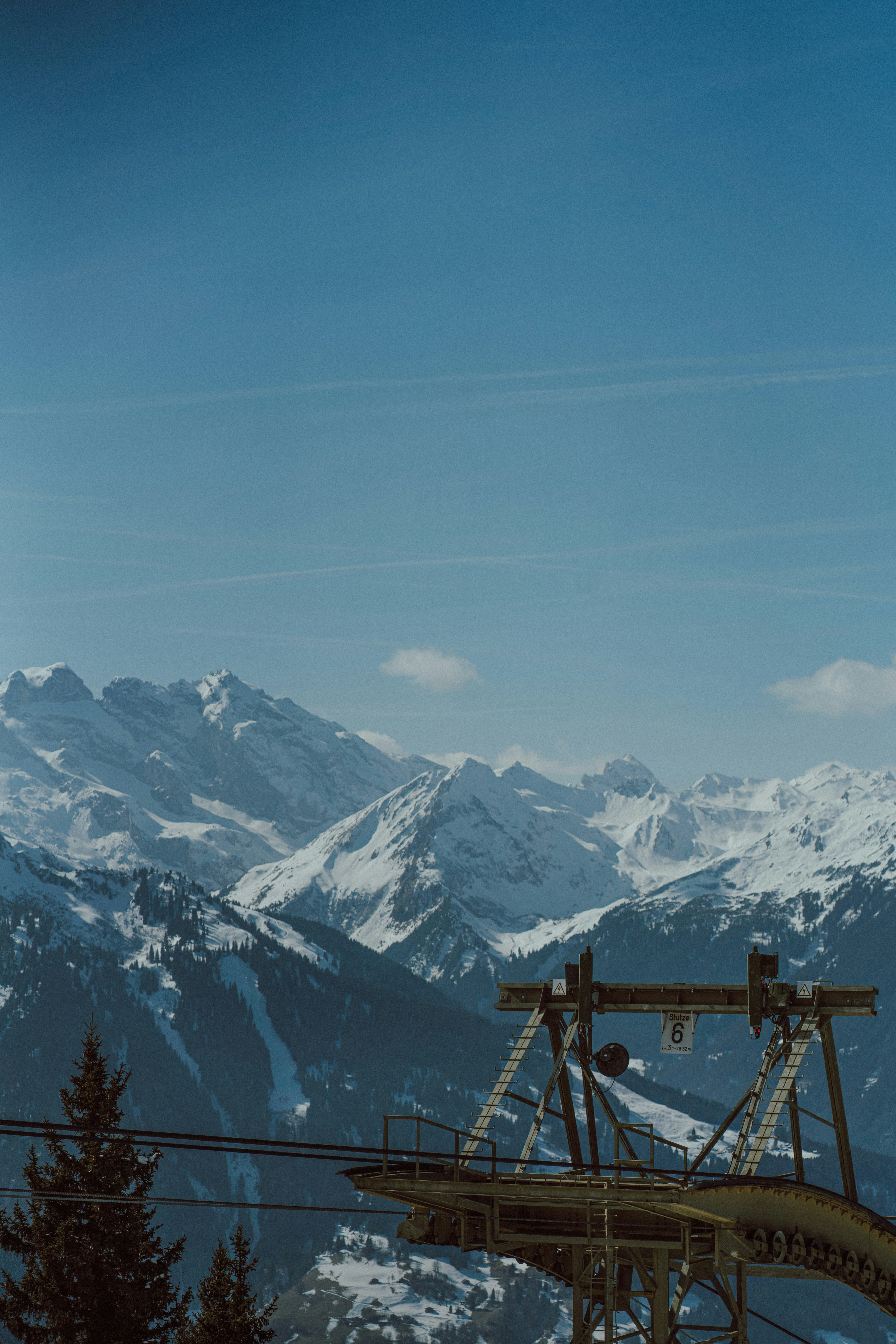 a ski lift going up a snowy mountain