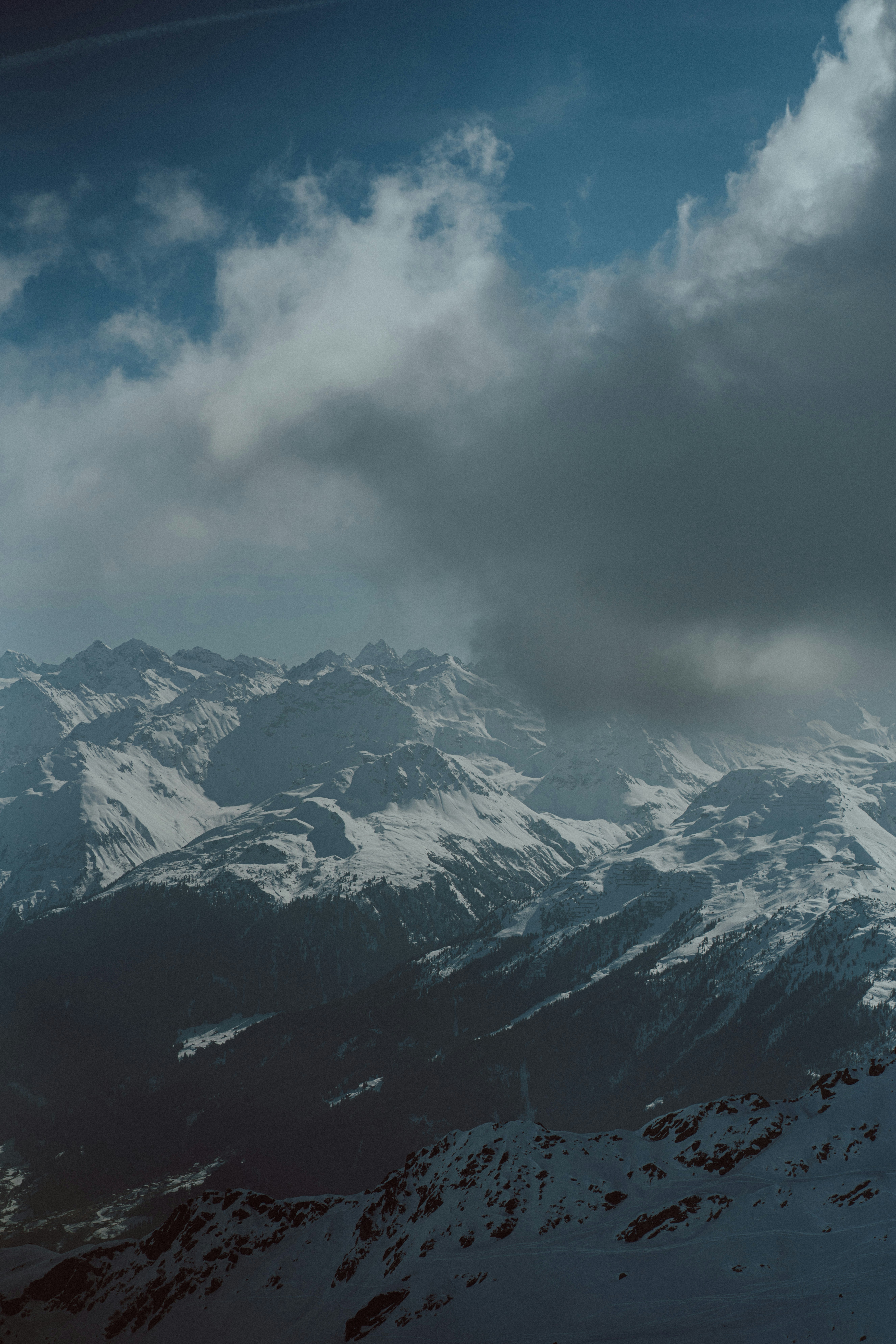 a plane flying over a snow covered mountain range