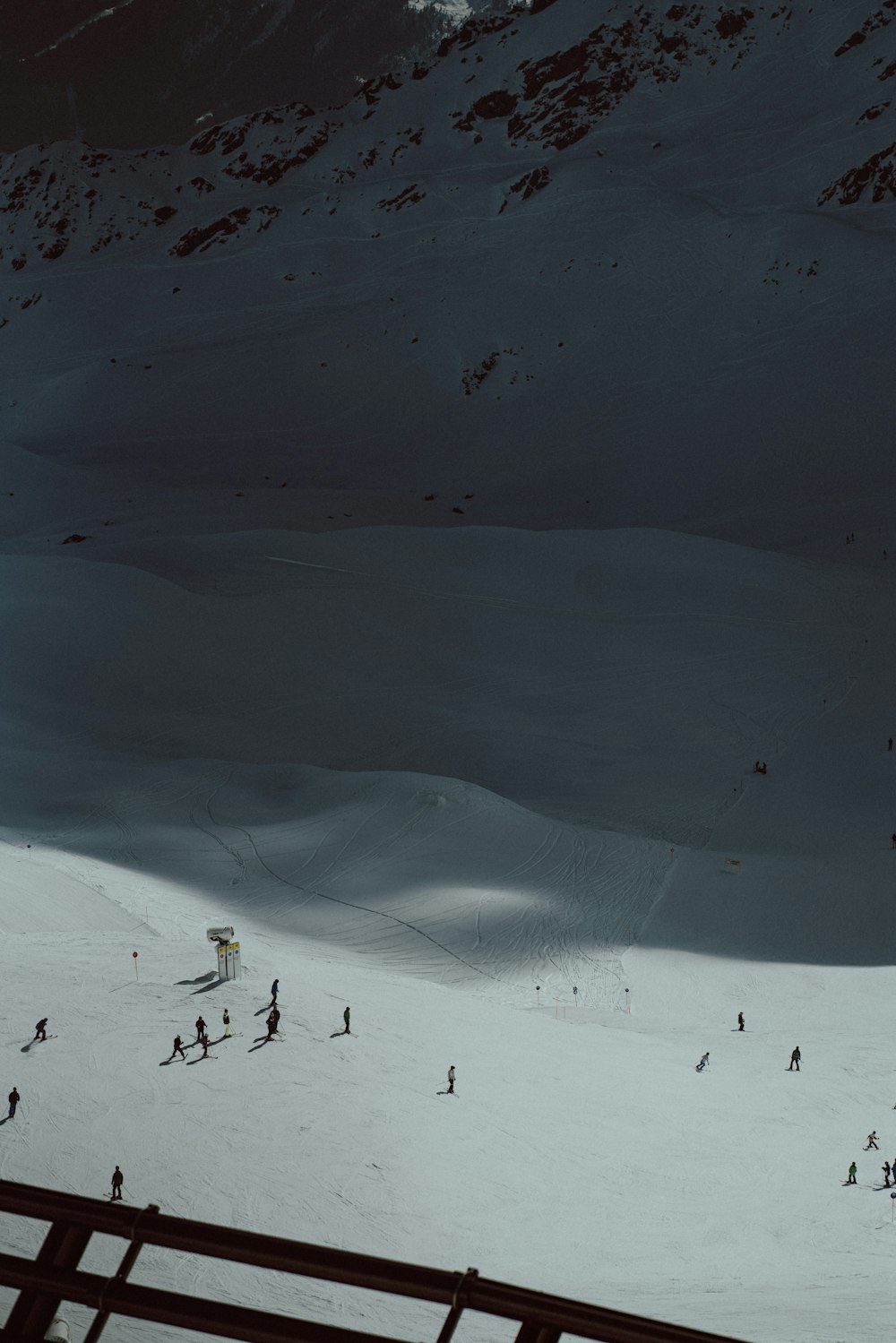 a group of people skiing down a snow covered slope