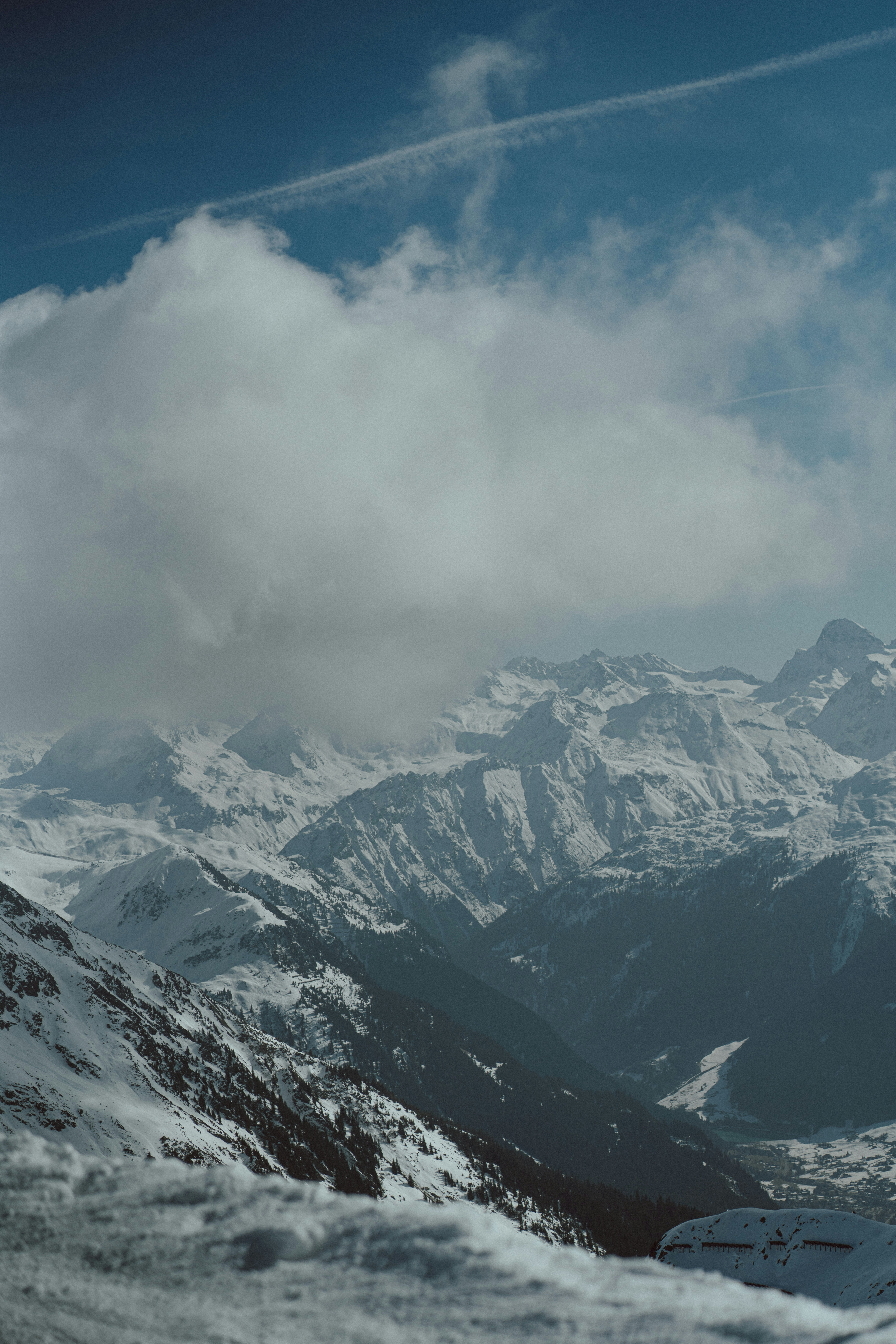 a view of a snowy mountain range from a ski slope
