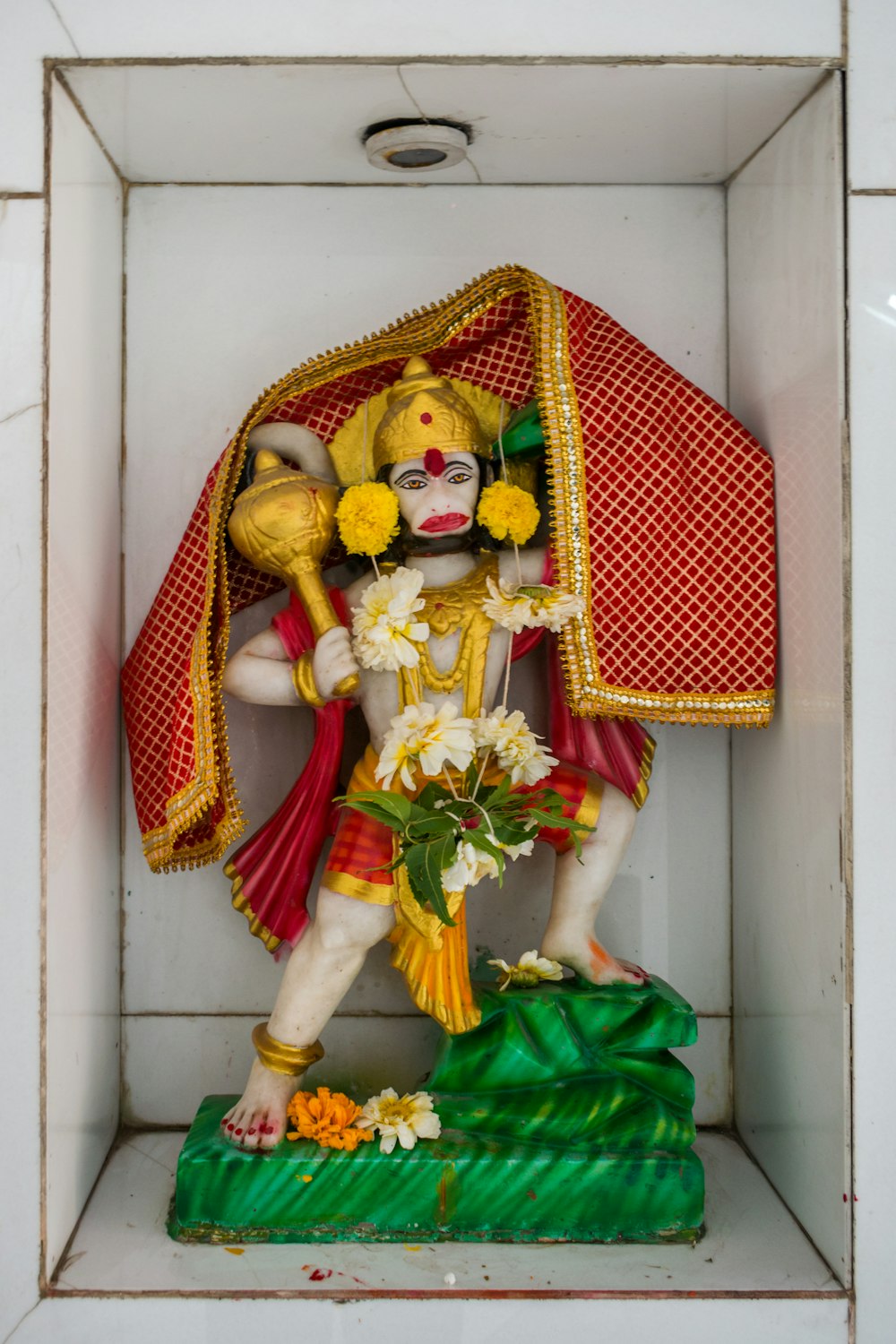 a statue of a hindu god in a niche