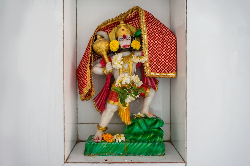 a statue of a hindu god in a niche