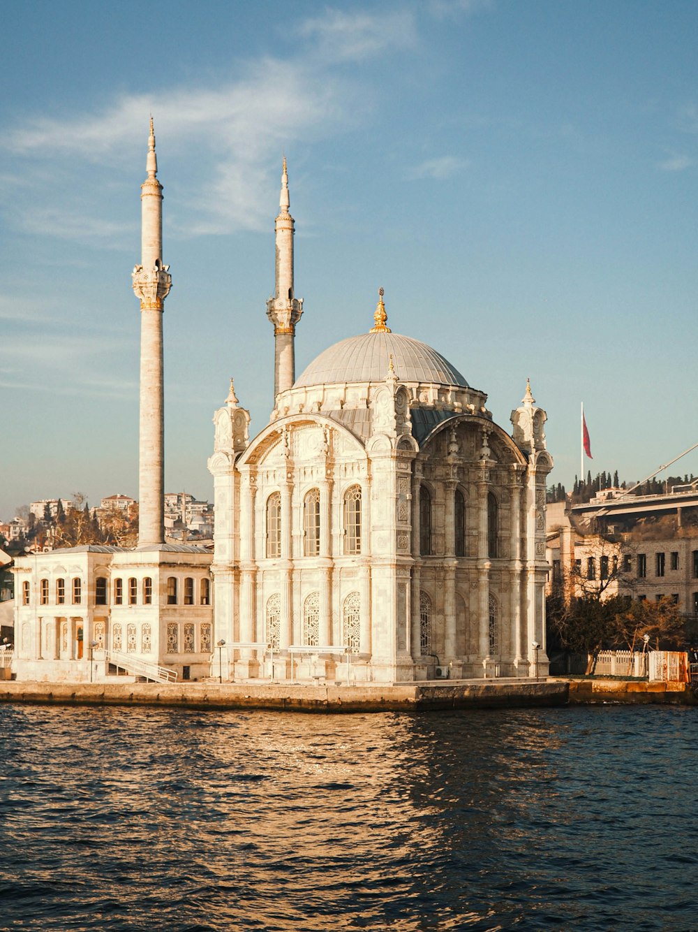 a large white building sitting on top of a body of water