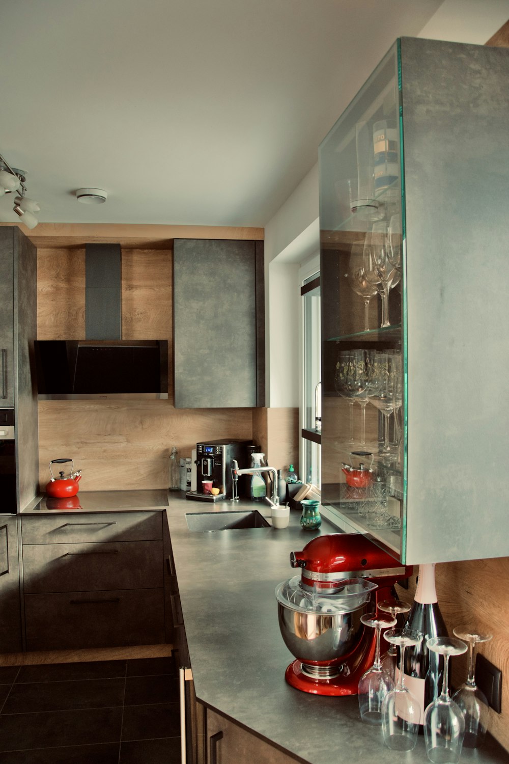 a red mixer sitting on top of a counter in a kitchen