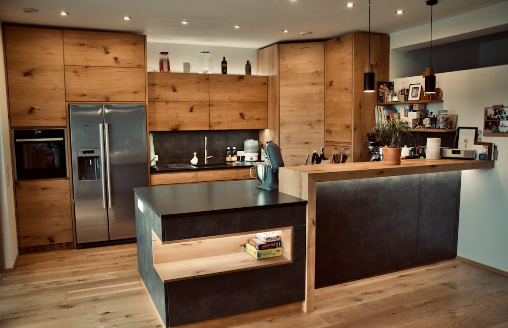 a kitchen with wooden cabinets and a stainless steel refrigerator