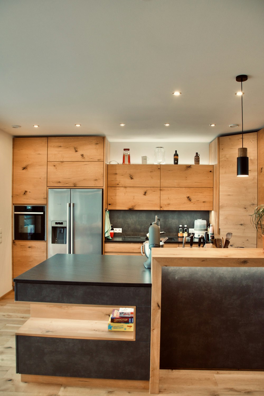 a kitchen with a center island and a refrigerator