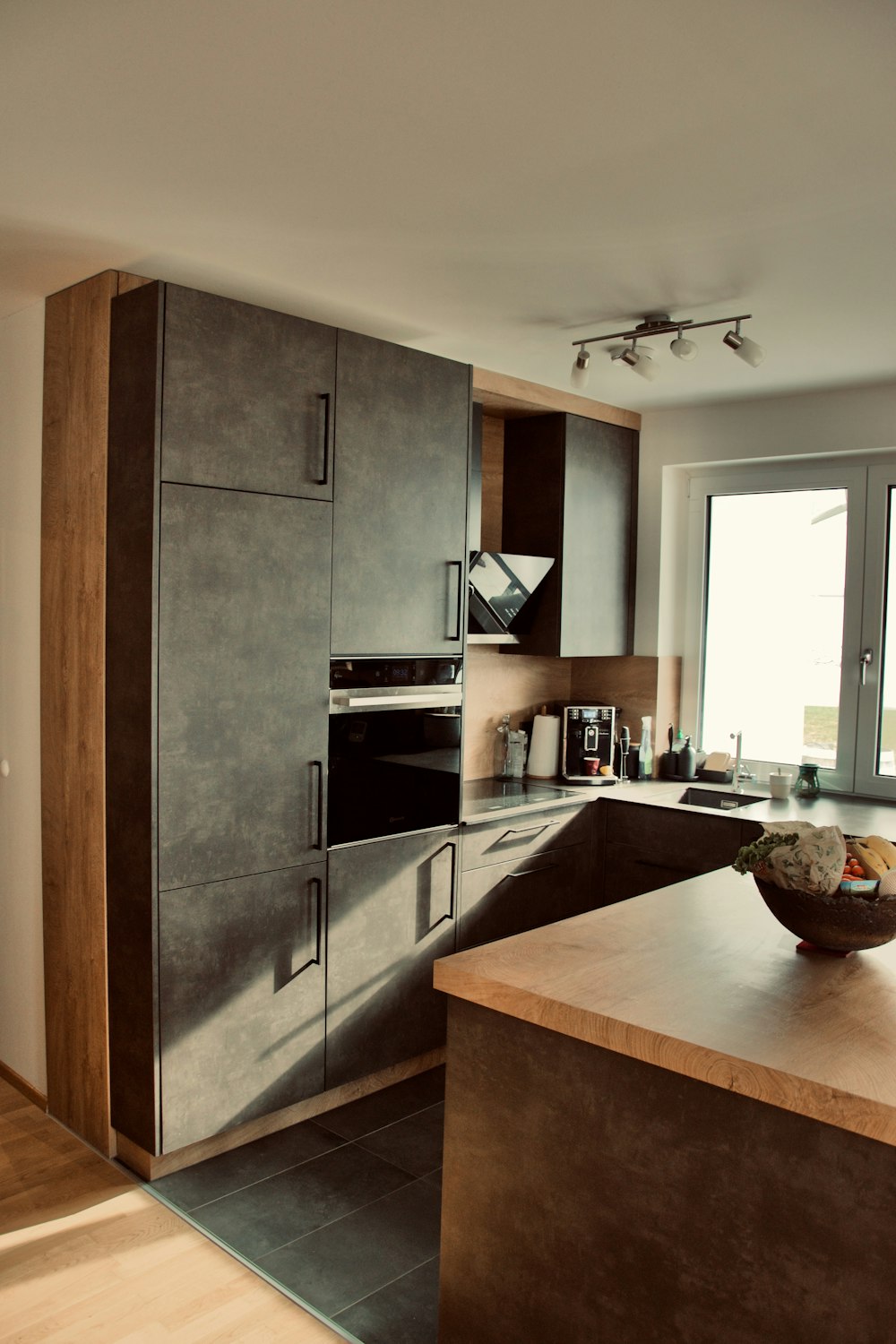 a kitchen with a bowl of fruit on the counter