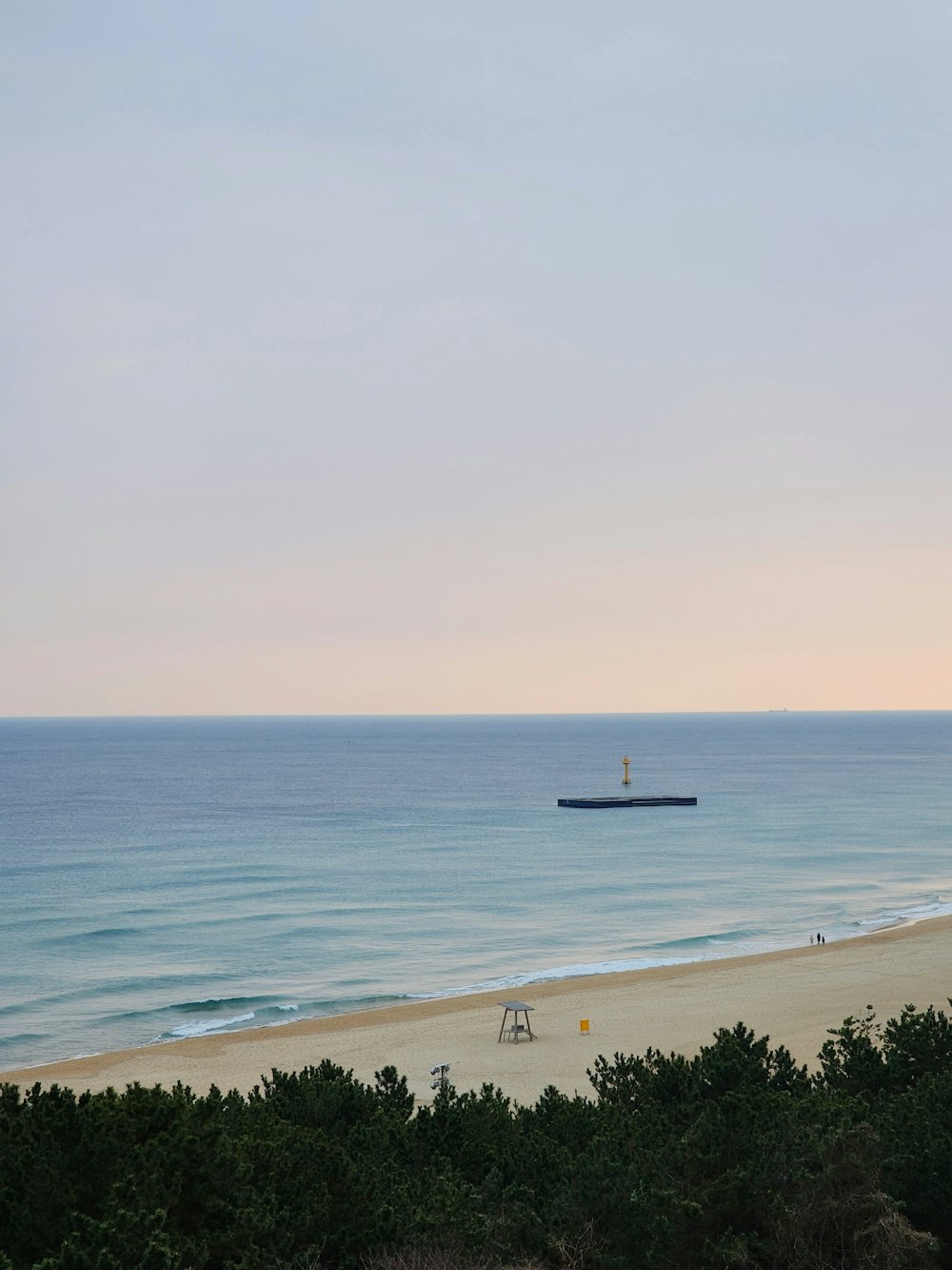 a view of a beach with a boat in the distance