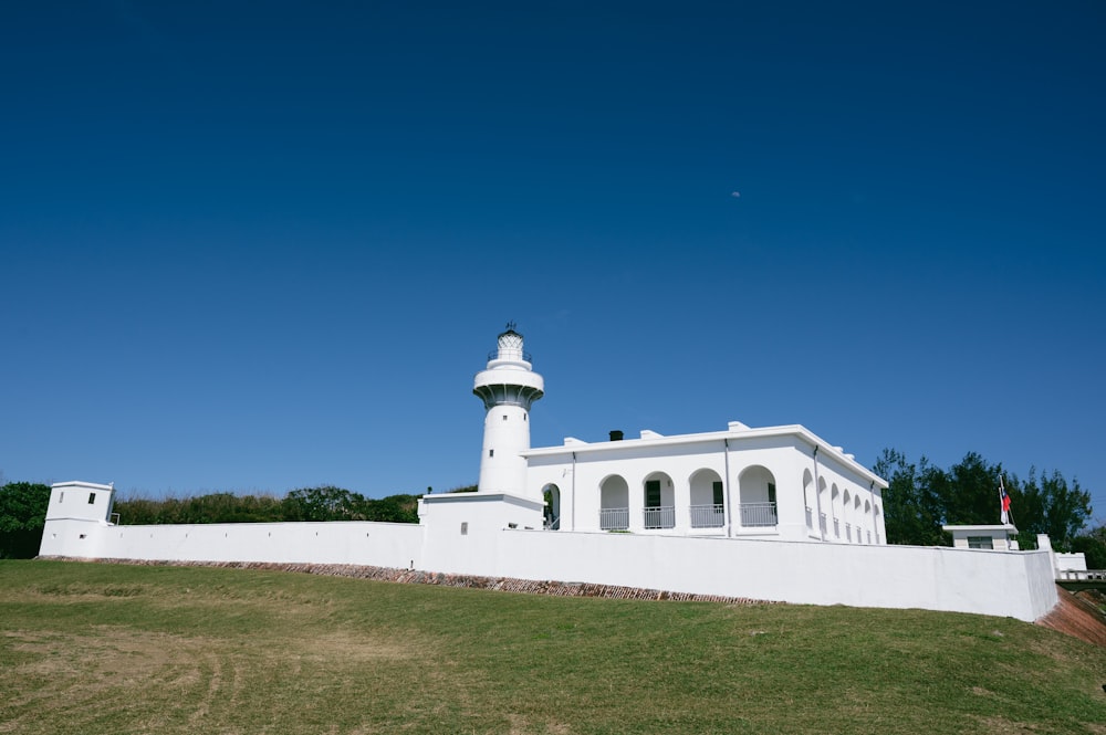 a white building with a light tower on top of it