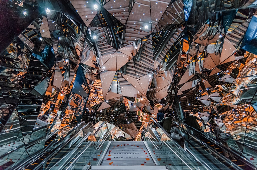 an escalator in a building with many mirrors on it