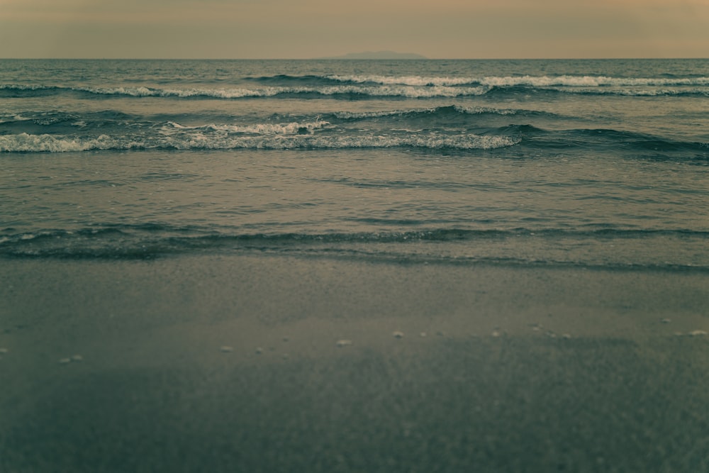 a beach with waves coming in and out of the water