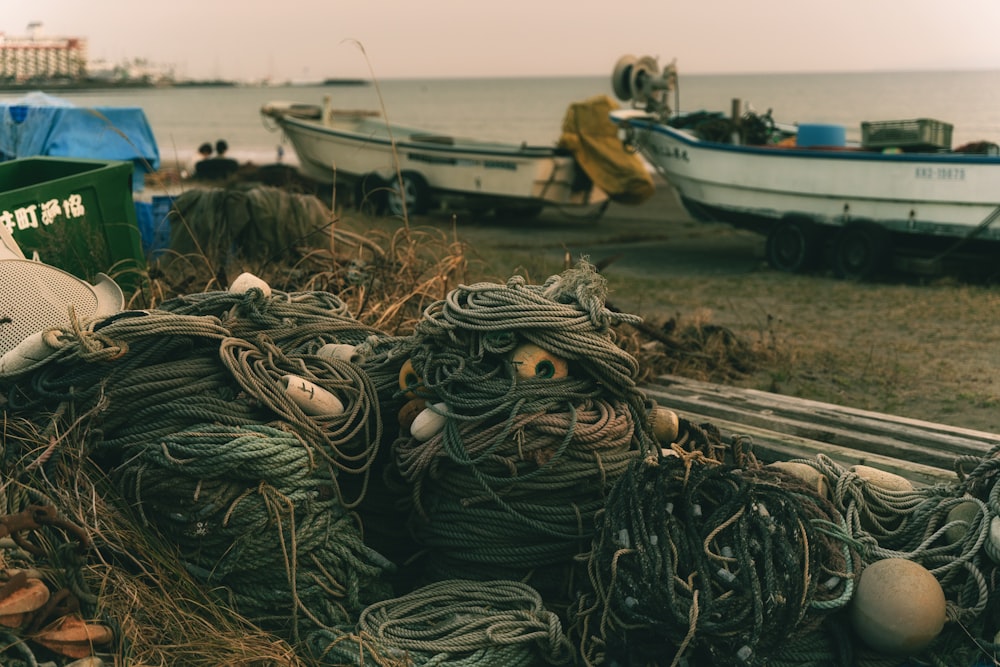 a pile of fishing nets sitting on top of a beach